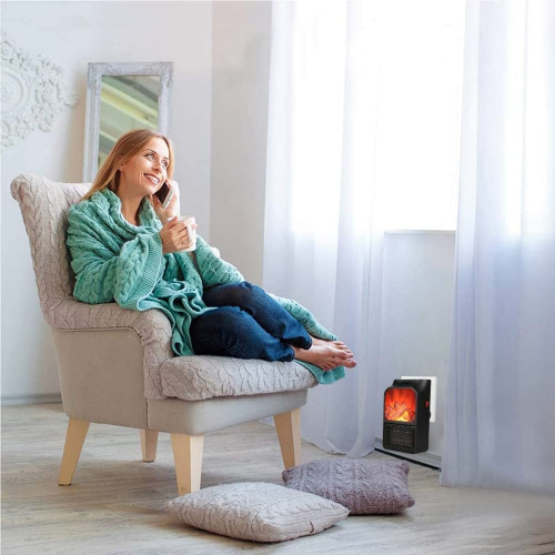 woman getting warm by Slava Heater in her living room